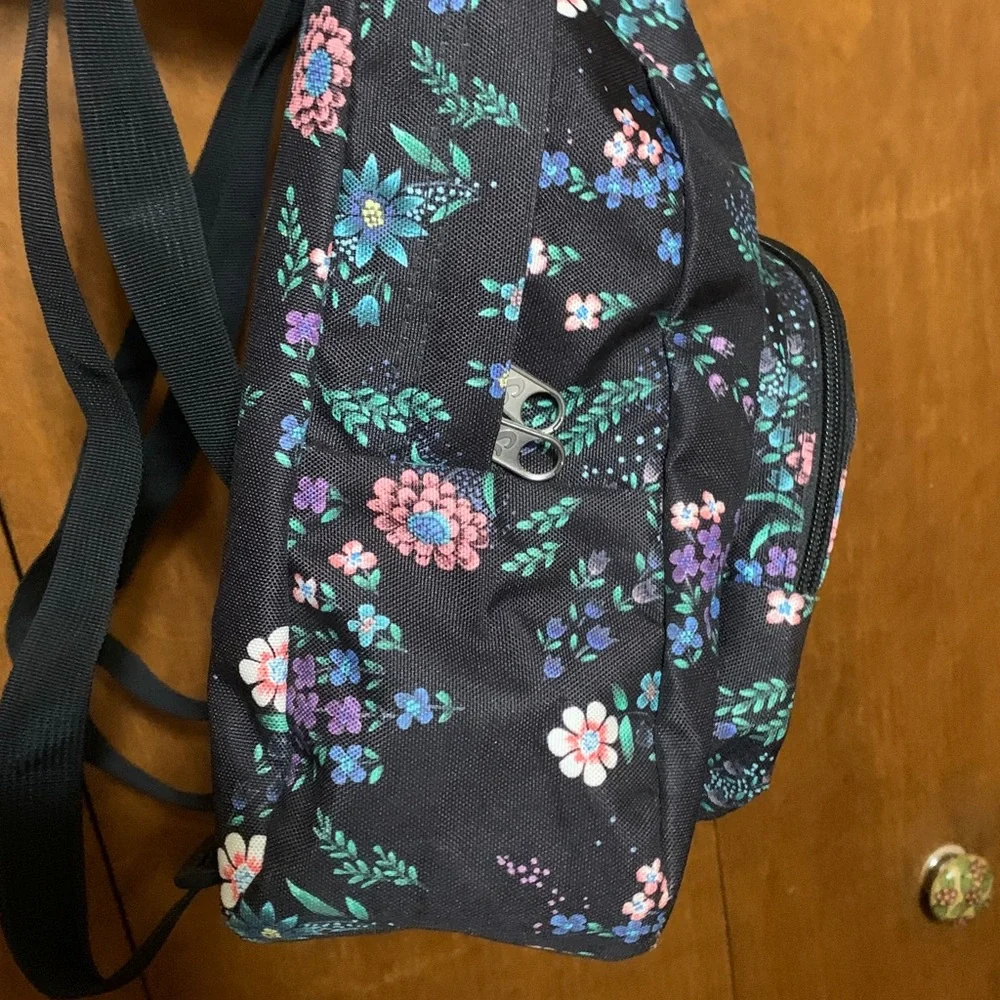 Jansport Black Mini Backpack with Pink, Purple & Green Floral Print.